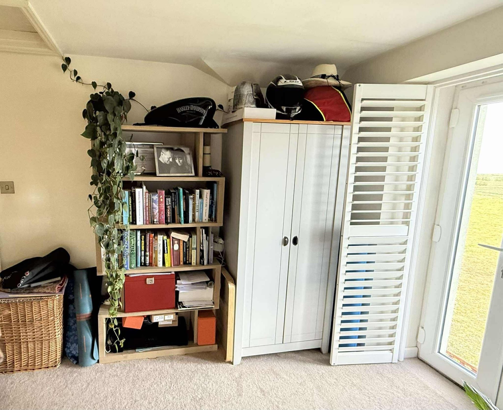 Cluttered bedroom corner before fitted wardrobes